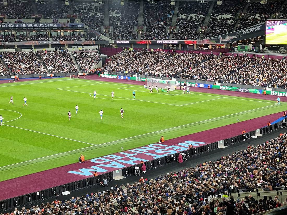A UEFA Europa League night match under floodlights at West Ham United's London Stadium