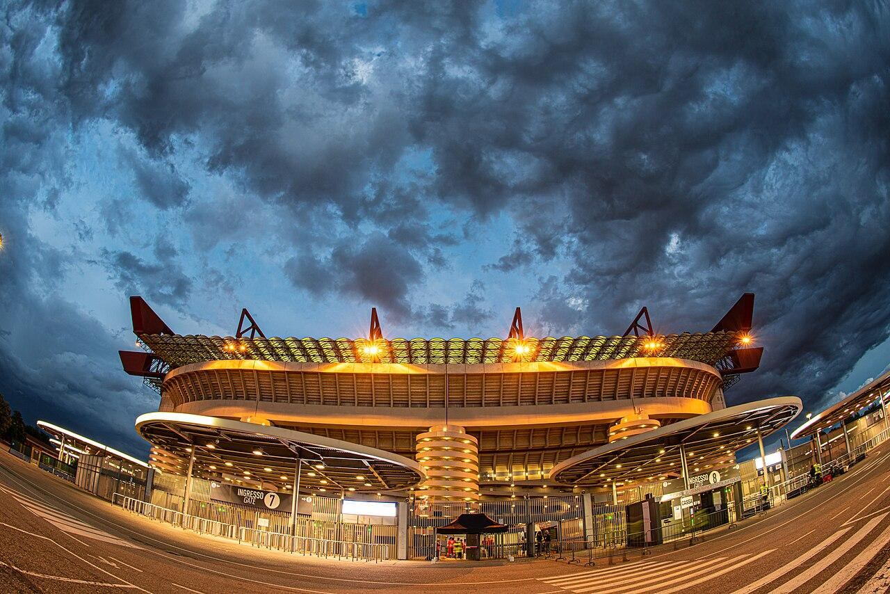 San Siro stadium in Milan lit up at dusk